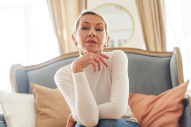 Kanepede oturan modern yaşlı kadın.