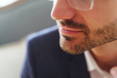 Modern Kafkasyalı gözlüklü adam içeride oturuyor.