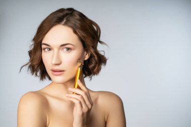 Yüz masajı yapan güzel bir kızın portresi.