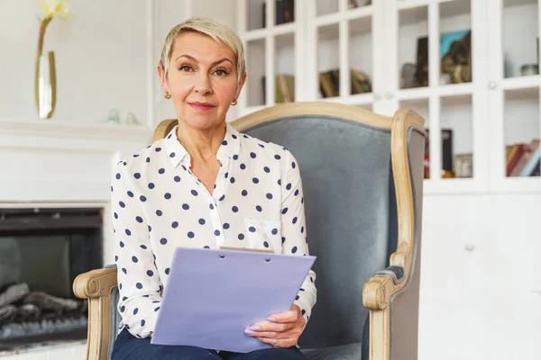 Elegante dama de negocios sentada en un sillón — Foto de Stock