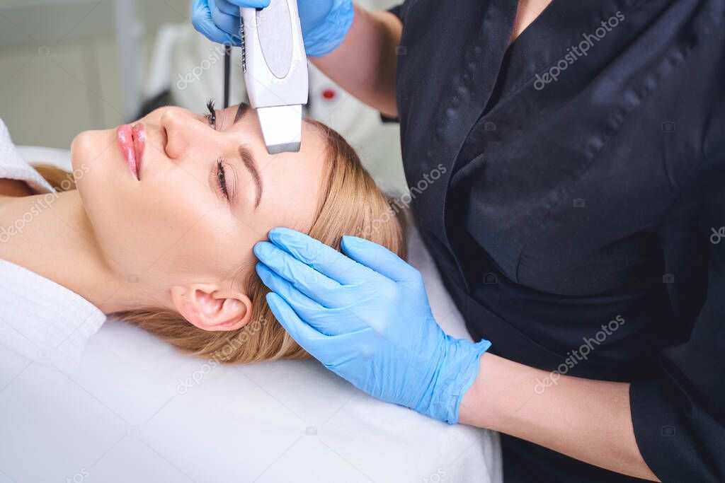 Cosmetologist doing facial for woman stock photo