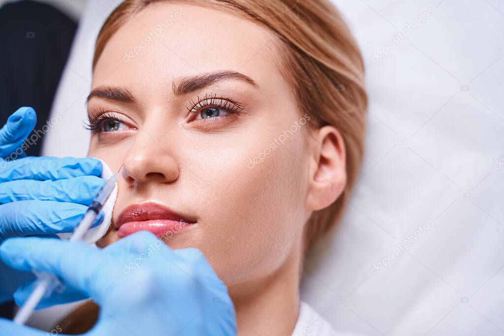 Relaxed female during botox injections stock photo