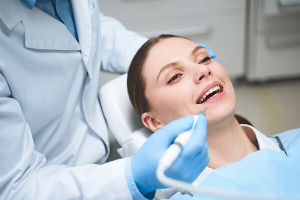 Happy woman during visit to dentist stock photo