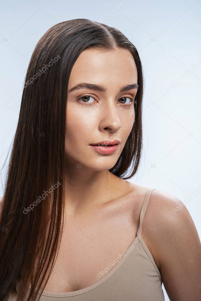 Young serene Caucasian woman with nude make-up
