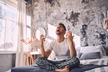 Negatif genç adam evde olmaktan memnun.