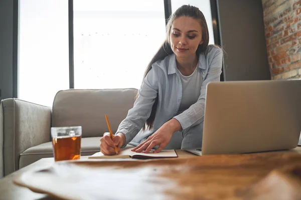 Mädchen schreibt mit Bleistift in ihr Tagebuch — Stockfoto