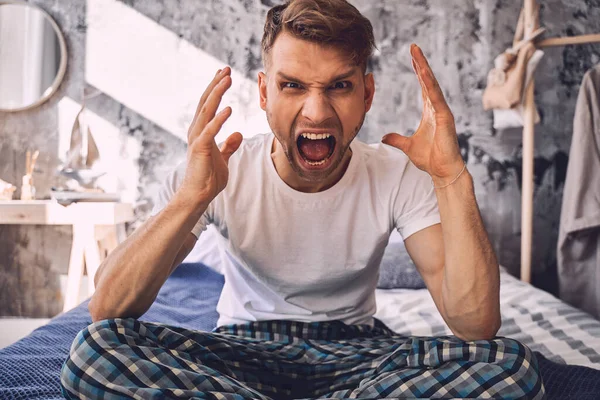 Negative delighted young man demonstrating his emotions — Stock Photo, Image