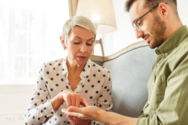 Focused client listening to a senior fortune-teller — Stock Photo, Image