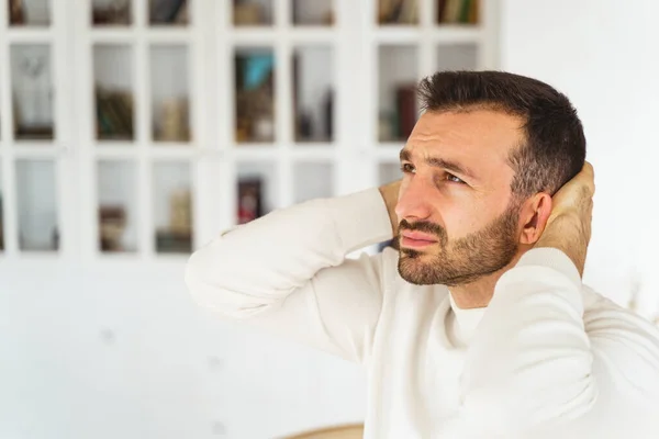 Upset young man staring into the distance — Stock Photo, Image