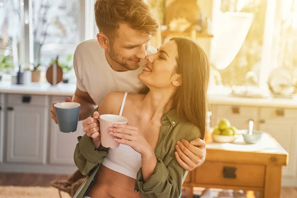 Happy young man embracing his tender partner — Stock Photo, Image