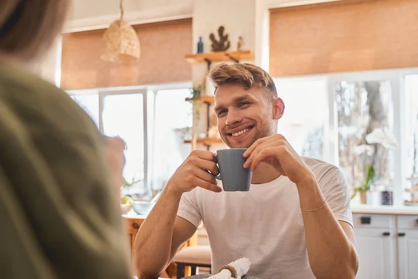 stock image Cheerful young man listening to his girlfriend