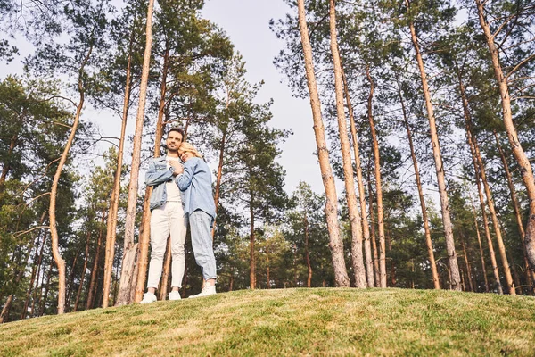 Dreamy man and his girlfriend standing outdoors — Stock Photo, Image
