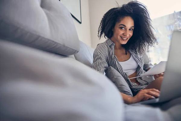 Flicka med dokument sittande på soffan — Stockfoto