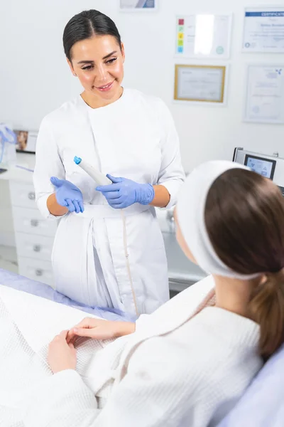 Pleased female doctor smiling at her patient — Stock Photo, Image