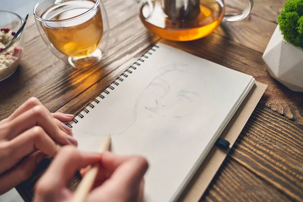 stock image Female artist drawing sketch in notebook at home