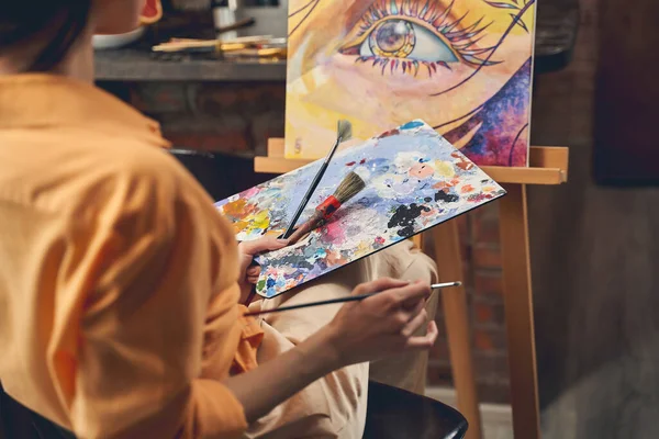 Female artist drawing picture with paints at home — Stock Photo, Image