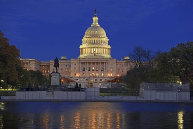The Capitol Building at night with reflection in water in Washington DC, capital of the United States of America clipart