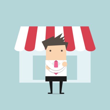 Dükkânın önünde duran işadamı