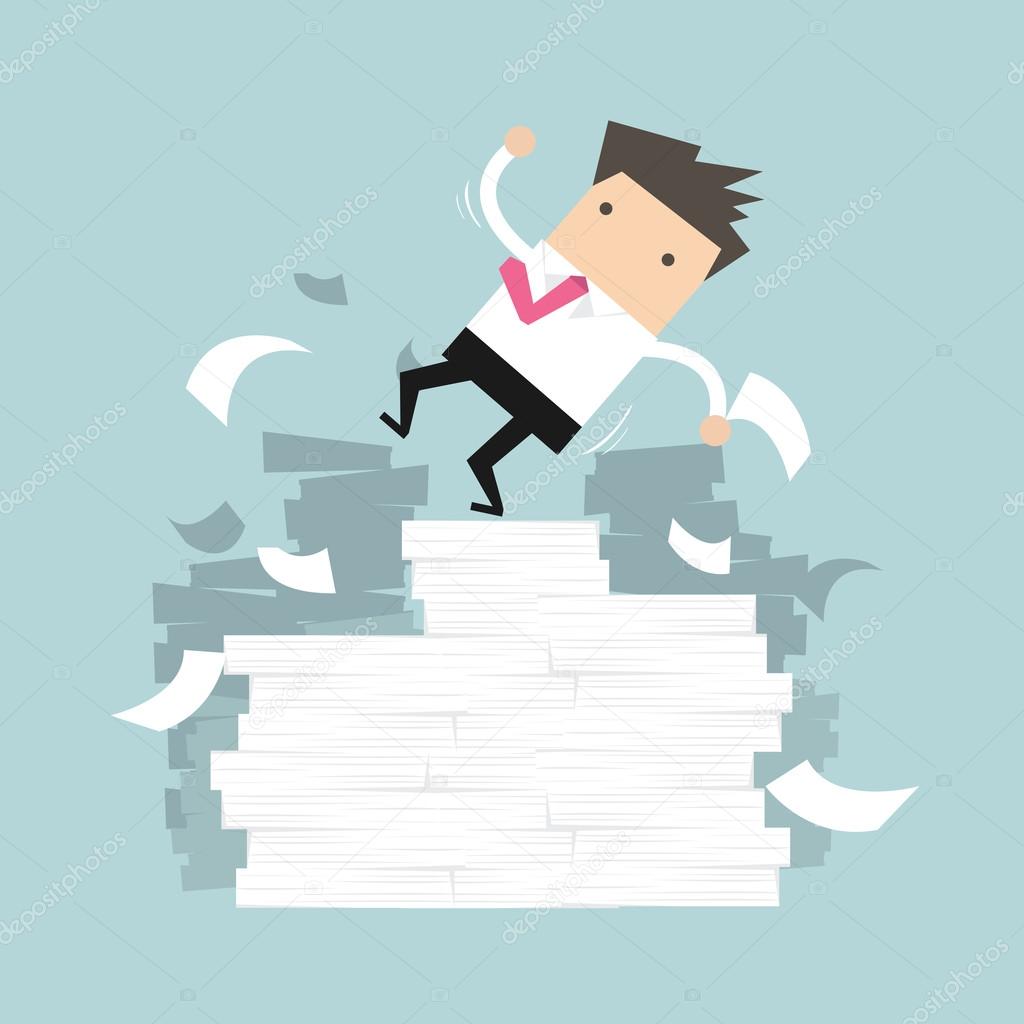 Businessman falling of paper mountain