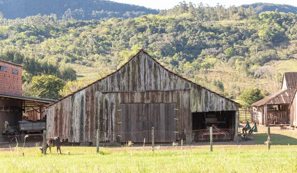 Old farm shed built with wood. building used for toolkeepers and the production of small rural property in southern Brazil.