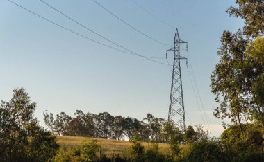 Bir güç iletim kulesi görüntüsü ve kırsal alandan geçen yüksek voltajlı kablolar. Brezilya 'da kırsal alan. Eğer elektrik iletimi yapılandırılırsa.