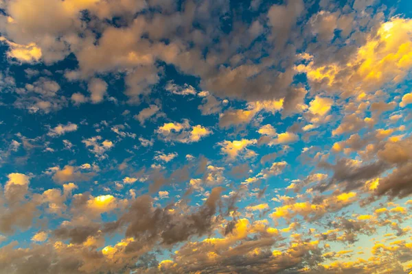 Late afternoon in the southern hemisphere and in the sky colorful cumulunimbus clouds. Contrast with the sunset. Colors of the evening in the Latin American sky.