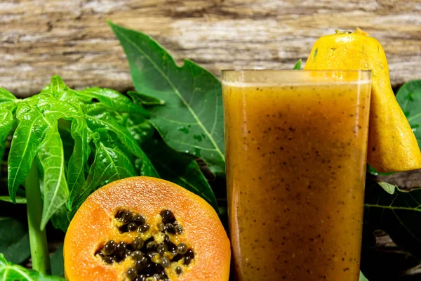 Formosa papaya juice and fruits, a typical Brazilian variety of common papaya as we know it. Papaya is a fruit with orange pulp that grows in tropical and subtropical regions
