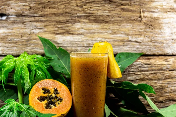 Formosa papaya juice and fruits, a typical Brazilian variety of common papaya as we know it. Papaya is a fruit with orange pulp that grows in tropical and subtropical regions