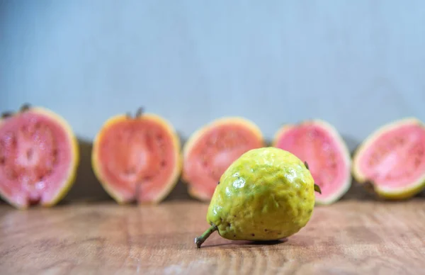 Guava fruits broken in half. Tropical fruits. Guavas in halves. Source of vitamin C. Fruit indicated for the immune system. antioxidant. Detox diet.
