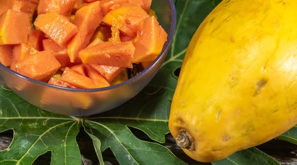 Chopped papaya fruit (Carica papaya L.) served in a bowl. The fruit, called papaya has this name because it has the shape of a breast, which earned it the popular name of papaya.