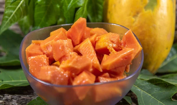 Chopped papaya fruit (Carica papaya L.) served in a bowl. The fruit, called papaya has this name because it has the shape of a breast, which earned it the popular name of papaya.