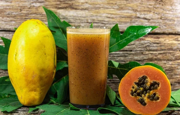 Papaya juice. Wood background. Fresh fruits. Detox drink. Tropical fruit drink. Papaya beat. Source of beta-carotene and lycopene. Fruit of the digestive system.