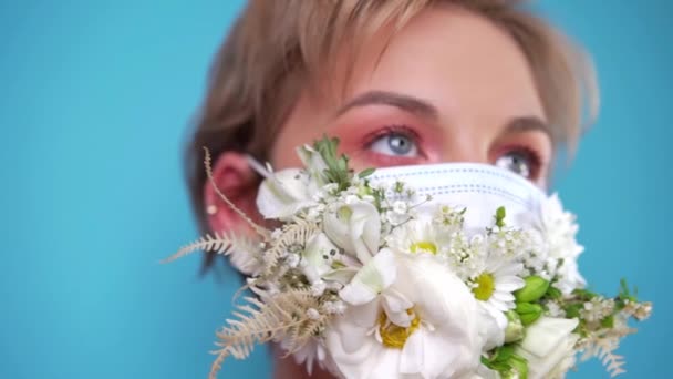 Face mask design with flowers. Portrait of beautiful woman with blue eyes, fashion make-up and mask — Stock Video