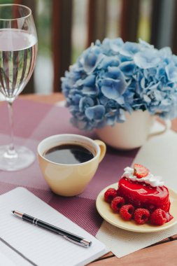 Balkonda sabah kahvaltısı, kruvasan, kahve ve böğürtlen.