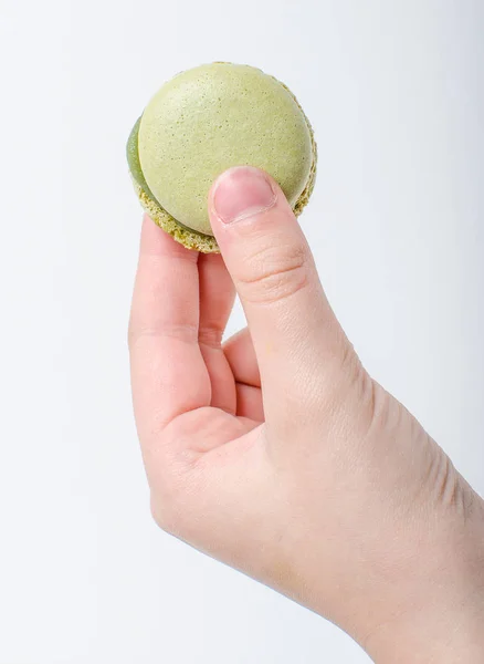 Colorful sweet macaroons in hand — Stock Photo, Image