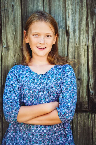 Portrait of a cute little girl of 8-9 years old, wearing blue dress — Stock Photo, Image