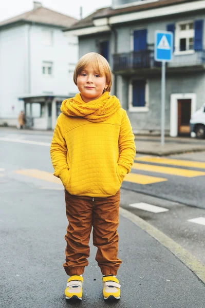 Outdoor fashion portrait of adorable 5-6 year old little blond boy, wearing yellow sweatshirt and scarf — Stock Photo, Image