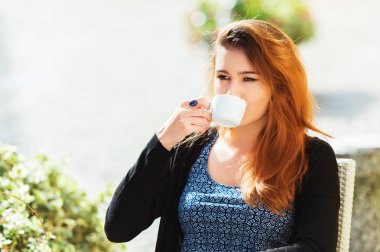 Genç kadın kahve café'de güneşli günde içme.