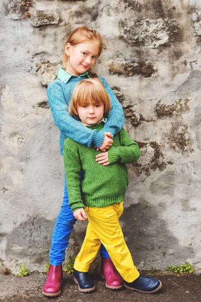 Outdoor portrait of two little kids, brother and sister, wearing colorful clothes — Stock Photo, Image