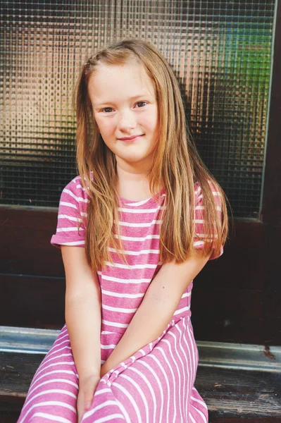 Close up portrait of a cute little girl of 7-8 years old leaning to pink  wall Stock Photo by ©annanahabed 122304756