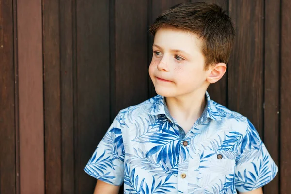 Funny stylish kid boy posing outdoors, wearing blue print shirt — Stock Photo, Image