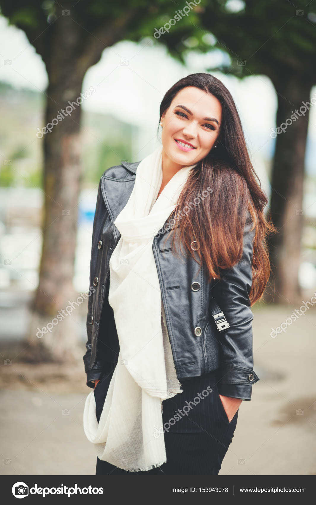 Outdoor Portrait Of Beautiful Brunette Woman With Long Hair