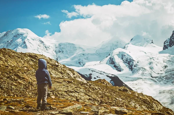 귀여운 소녀 밝은 무지개 색된 코트를 입고 Gornergrat 빙하, 스위스 앞에 서 있는 스위스 국기를 들고 — 스톡 사진