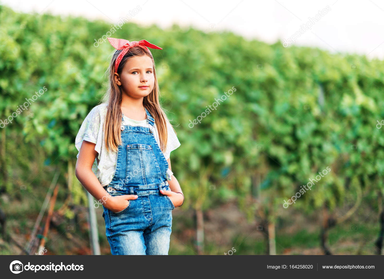 little girl in overalls