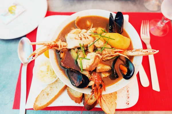 Dish of Bouillabaisse with rouille croutes served at the restaurant — Stock Photo, Image