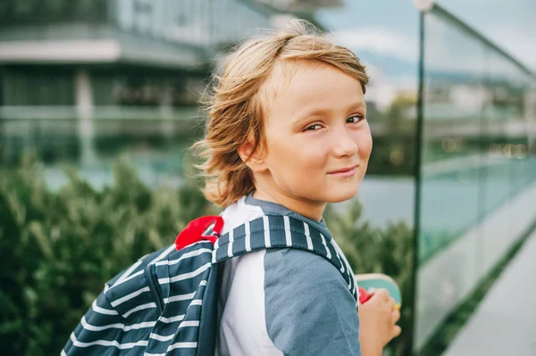 Close up portrait of young cute little 6 year old boy wearing backpack, back to school. Candid small schoollboy, film look filter image — Stock Photo, Image