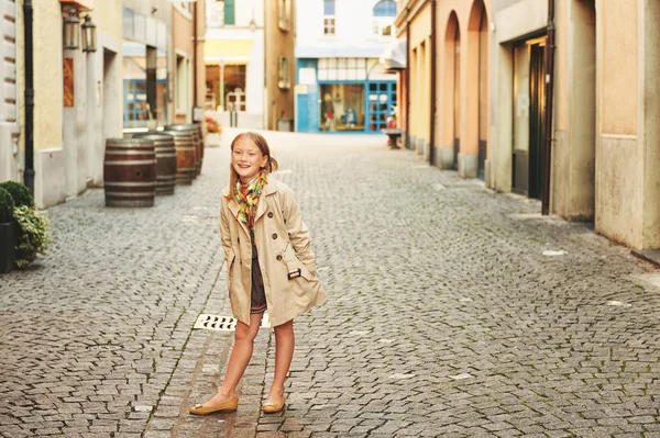 Outdoor fashion portrait of 8-9 year old hipster girl wearing stylish trench coat — Stock Photo, Image