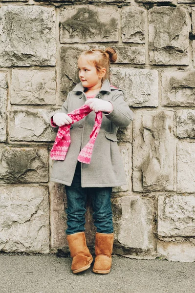 Outdoor vertical portrait of pretty little girl wearing grey coat, autumn fashion for kids — Stock Photo, Image