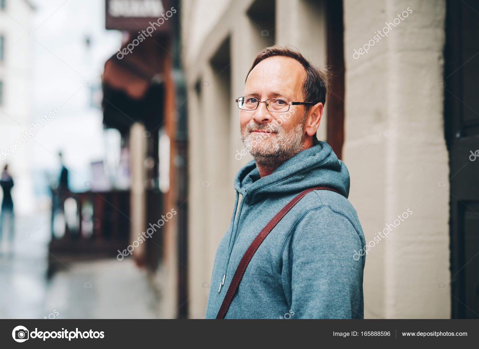 50 year old man with glasses Outdoor portrait of 50 year old man wearing blue hoody and