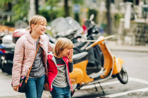 Street fashion for children. Boy and girl wearing padded jackets. Little brother and sister spending time together — Stock Photo, Image